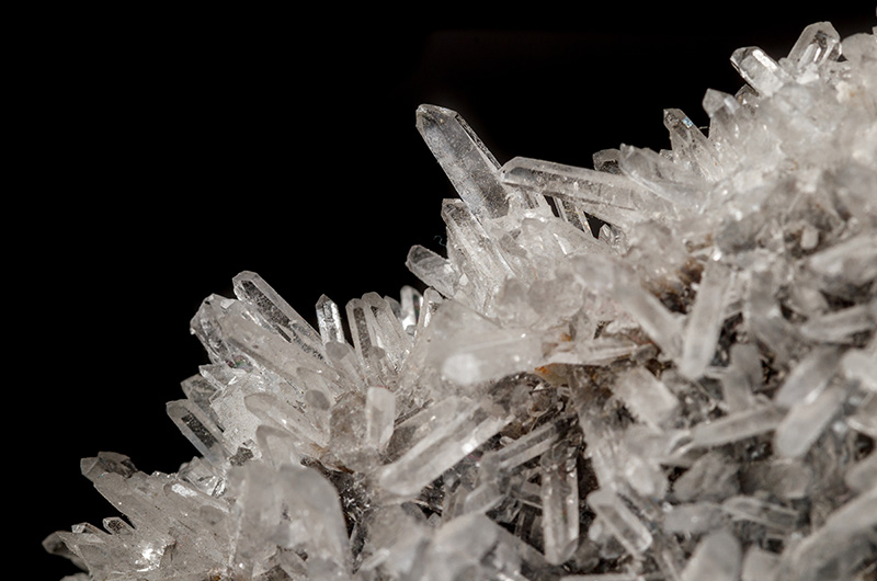 Macro mineral stone sulfite quartz on a black background